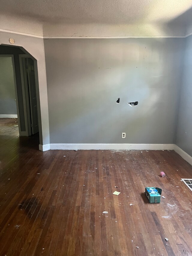 11717 Grayton St, Detroit, MI 48224 - empty room with hardwood / wood-style flooring, baseboards, arched walkways, and a textured ceiling