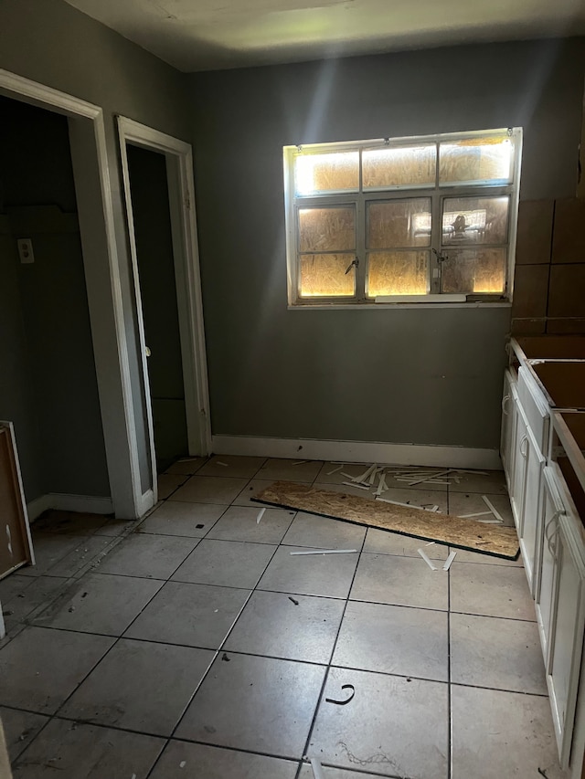 unfurnished dining area with light tile patterned floors