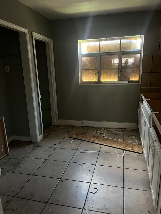 11717 Grayton St, Detroit, MI 48224 - unfurnished bedroom with baseboards and light tile patterned flooring
