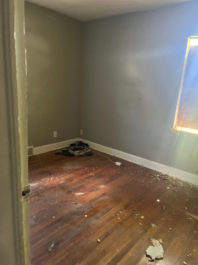 empty room with dark wood-type flooring