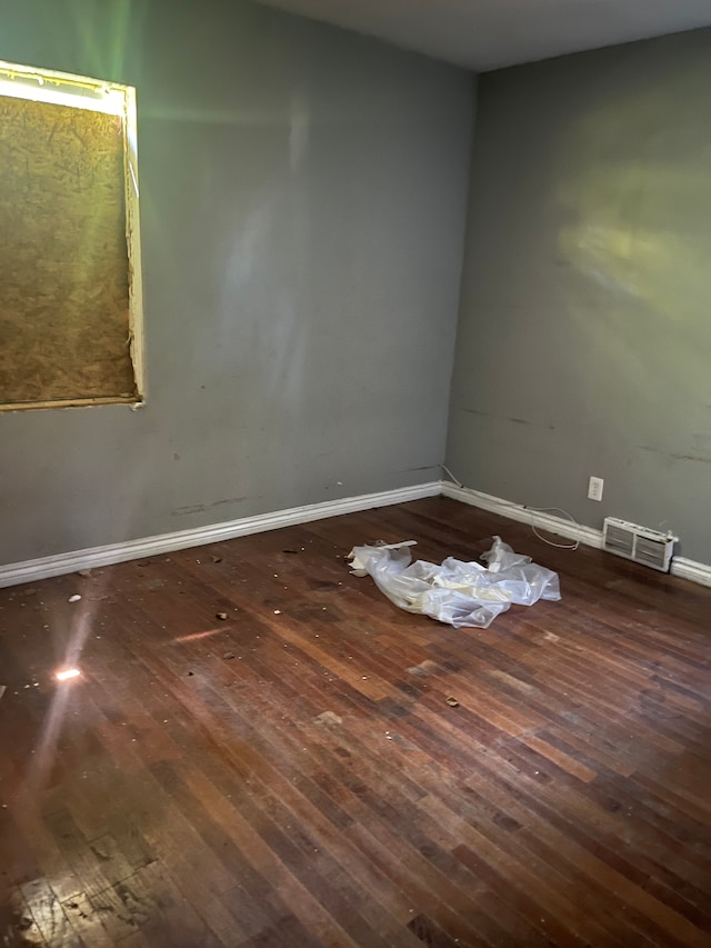 unfurnished room with dark hardwood / wood-style flooring