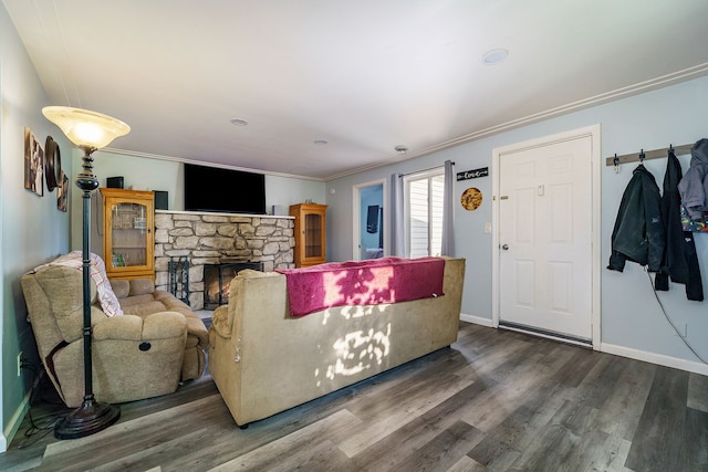 living room with crown molding, a fireplace, and hardwood / wood-style flooring