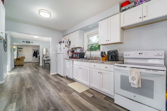 kitchen featuring white cabinets, white appliances, sink, and light hardwood / wood-style flooring