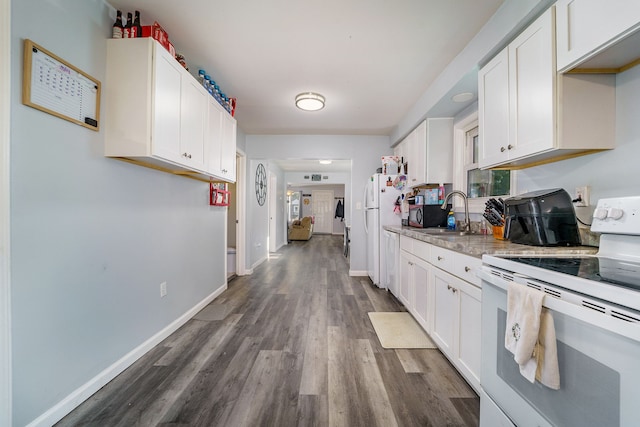 kitchen with white cabinets, white appliances, sink, and dark wood-type flooring