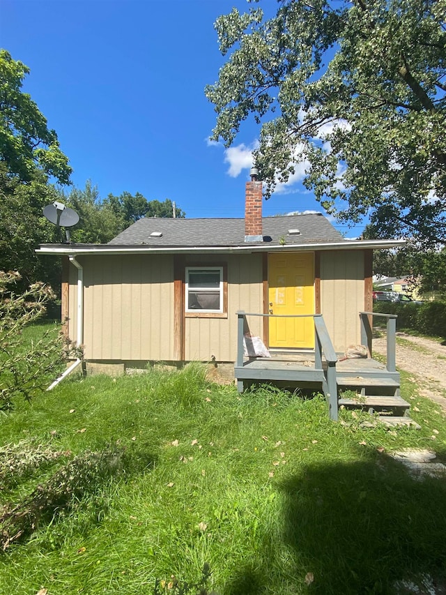 rear view of house featuring a lawn