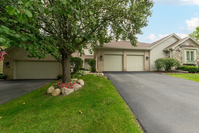 view of front of property with a front yard and a garage