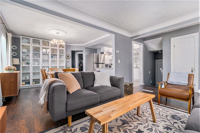 living room featuring hardwood / wood-style floors, a textured ceiling, and a chandelier