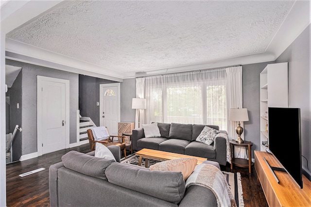 living room featuring a textured ceiling and dark hardwood / wood-style floors