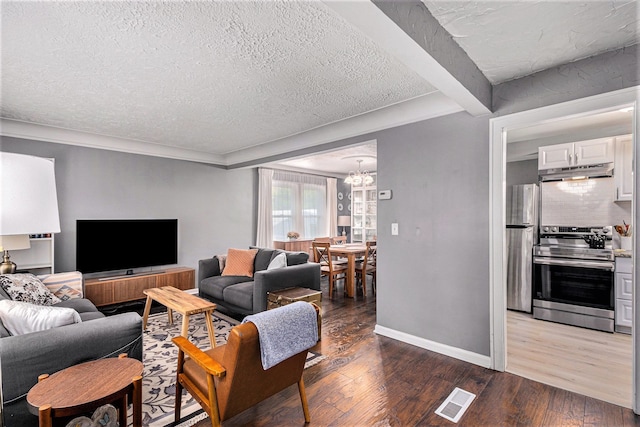 living room featuring beam ceiling, a textured ceiling, dark hardwood / wood-style floors, and a notable chandelier