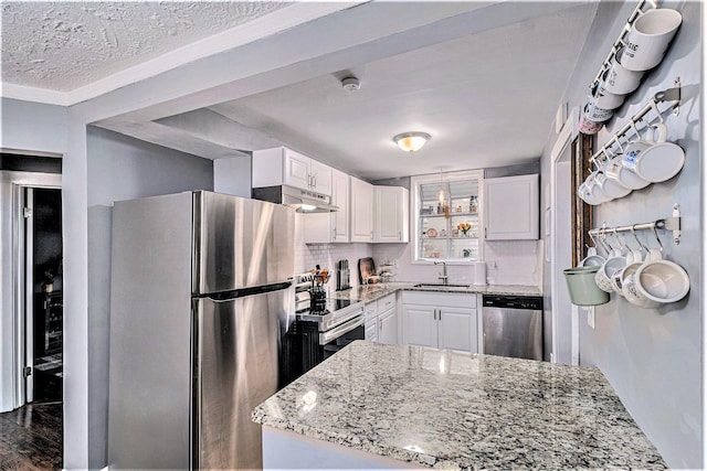 kitchen featuring light stone countertops, appliances with stainless steel finishes, dark wood-type flooring, sink, and white cabinetry