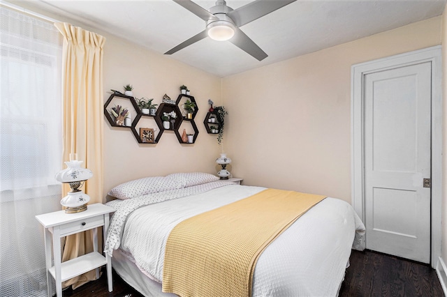 bedroom with dark hardwood / wood-style floors and ceiling fan