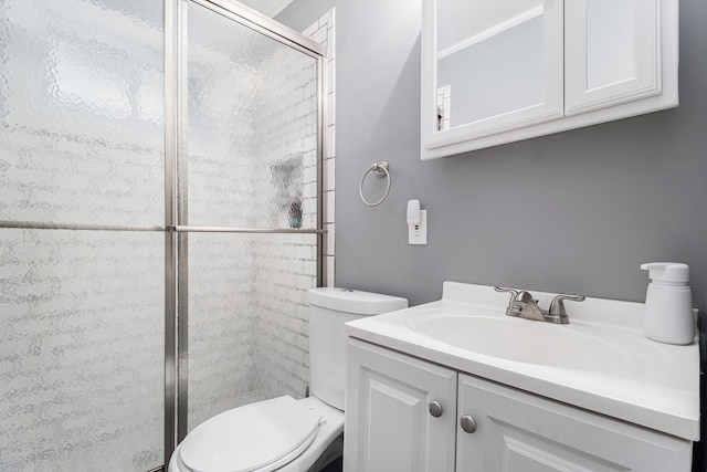 bathroom featuring vanity, toilet, and walk in shower