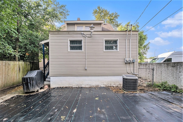 exterior space featuring central AC unit and a deck