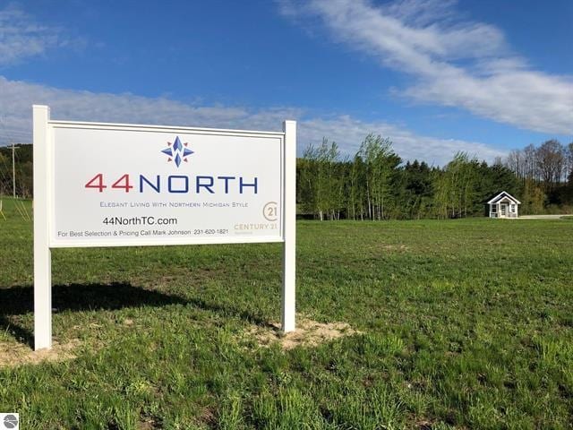 community / neighborhood sign with a yard