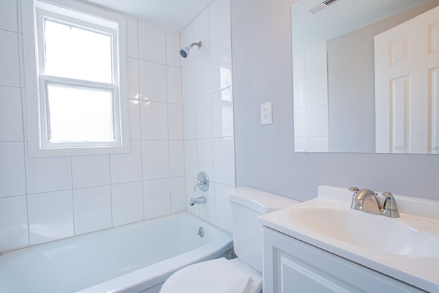 full bathroom featuring vanity, toilet, and tiled shower / bath