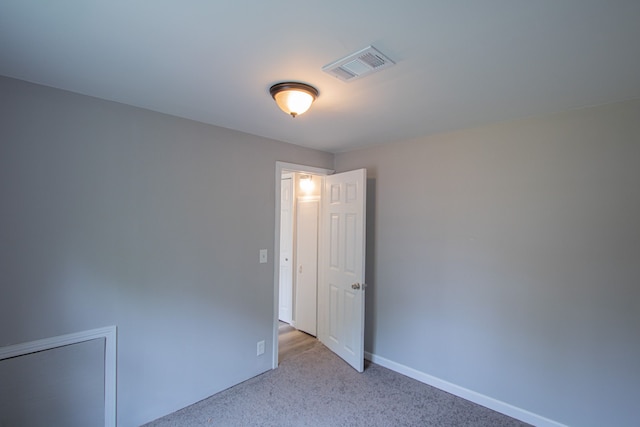 spare room with light carpet