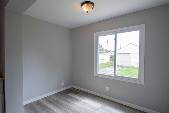 empty room featuring light wood-type flooring and a wealth of natural light