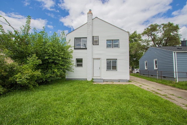 back of house featuring a yard