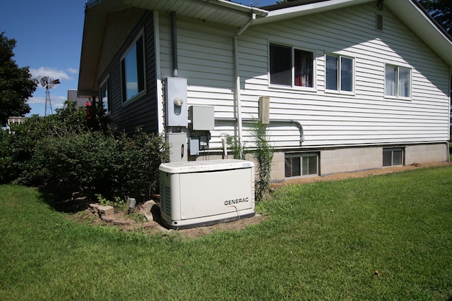 view of side of home with a yard