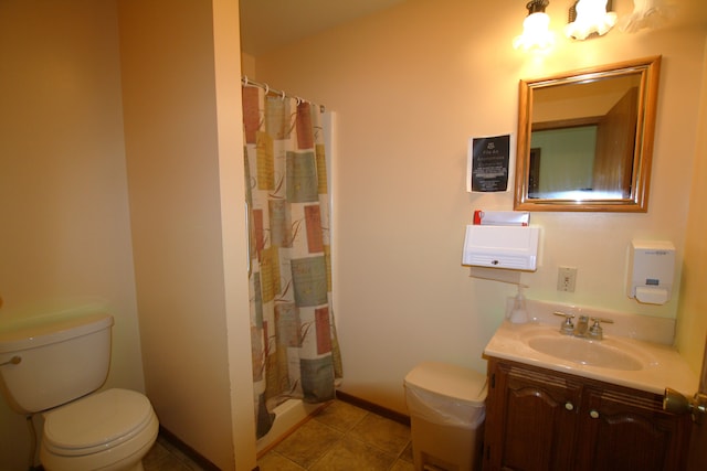 bathroom with curtained shower, tile patterned flooring, vanity, and toilet