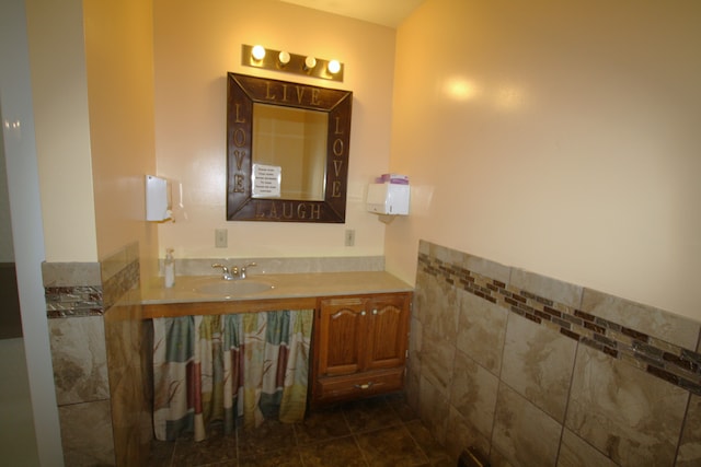 bathroom with vanity, tile patterned floors, and tile walls