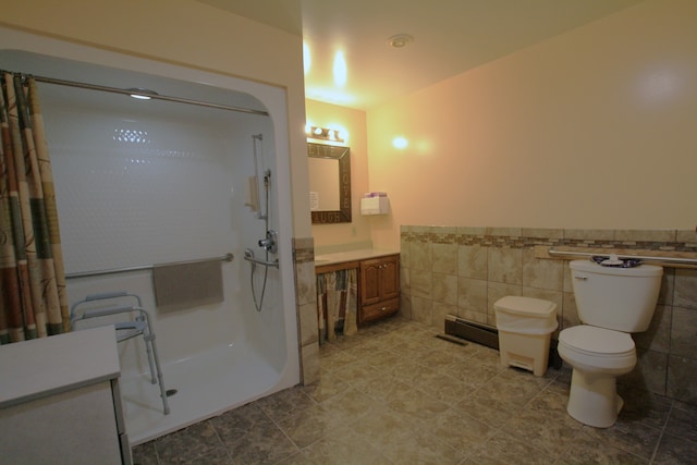 bathroom with a shower with curtain, tile patterned flooring, vanity, and tile walls