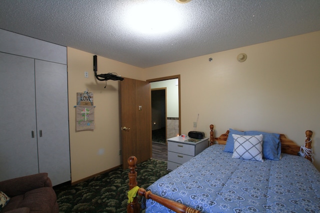 bedroom with a textured ceiling and a closet