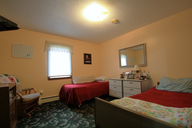 carpeted bedroom with a textured ceiling and baseboard heating