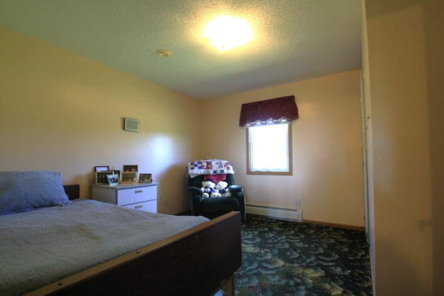 carpeted bedroom featuring a textured ceiling and a baseboard heating unit