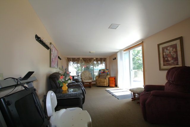 living room with carpet flooring and a healthy amount of sunlight