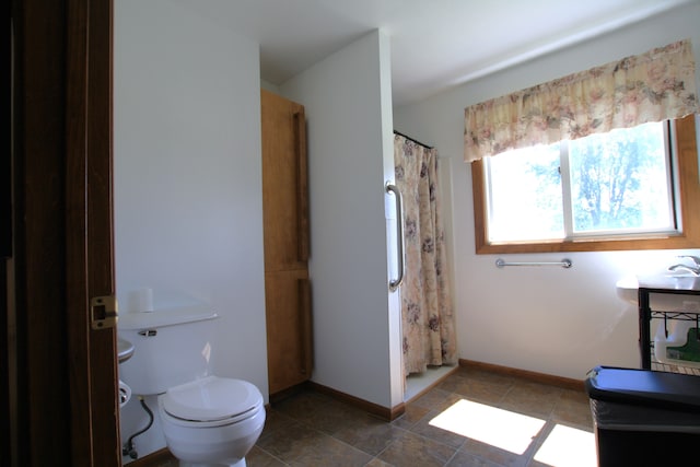 bathroom with a shower with curtain and toilet