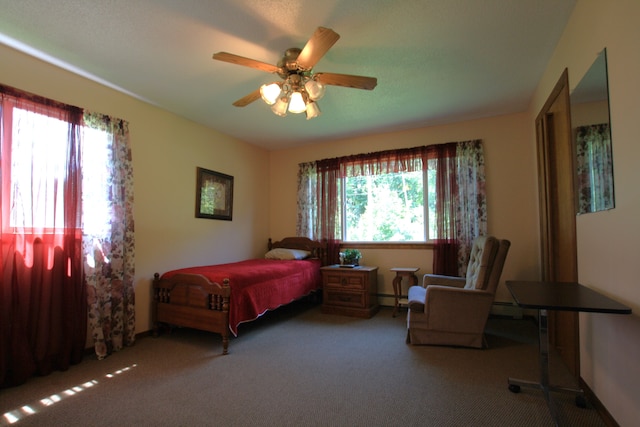 bedroom featuring carpet flooring, multiple windows, ceiling fan, and baseboard heating