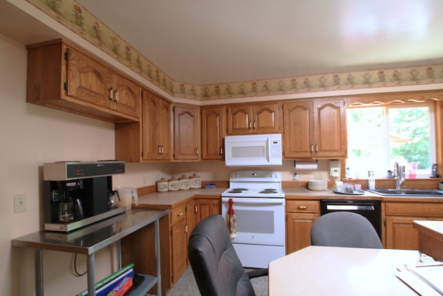 kitchen featuring white appliances and sink