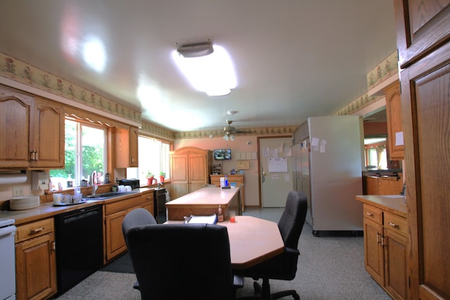 kitchen with dishwasher, ceiling fan, sink, and light carpet