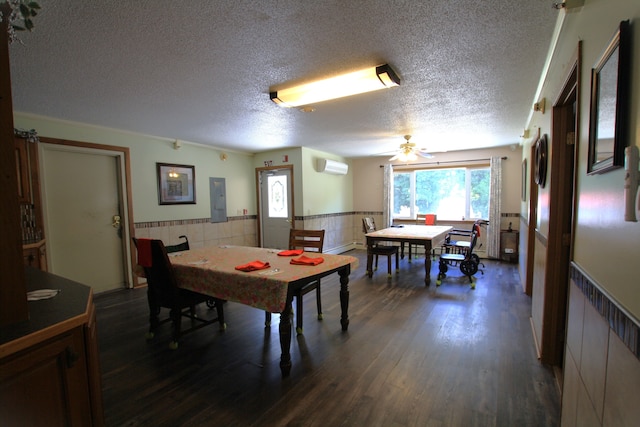 dining area featuring ceiling fan, dark hardwood / wood-style flooring, a textured ceiling, and a wall unit AC