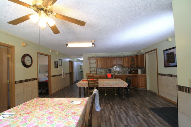 dining space with dark hardwood / wood-style floors, ceiling fan, and a textured ceiling