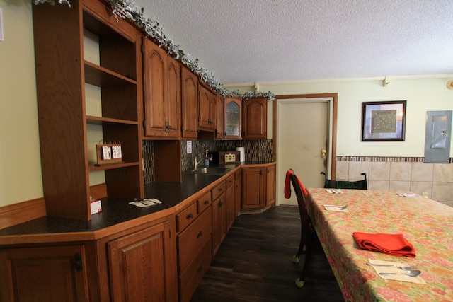 kitchen with a textured ceiling, backsplash, dark hardwood / wood-style floors, and sink