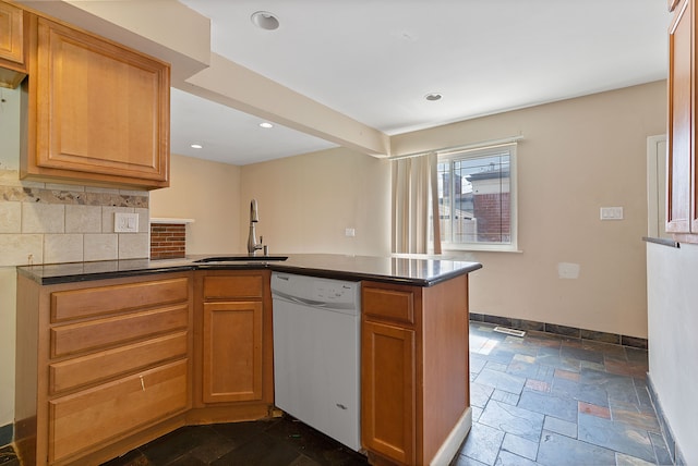 kitchen with kitchen peninsula, decorative backsplash, sink, and white dishwasher