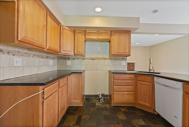 kitchen with backsplash, sink, and white dishwasher