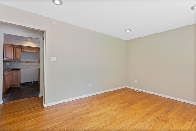 spare room featuring light hardwood / wood-style floors