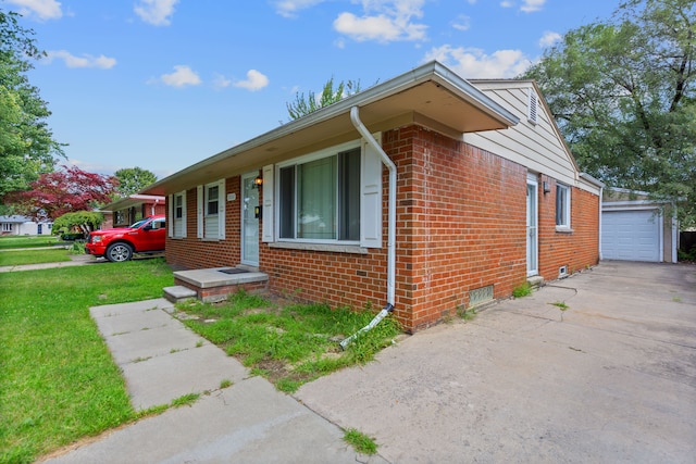 view of front of property with a garage, an outdoor structure, and a front yard