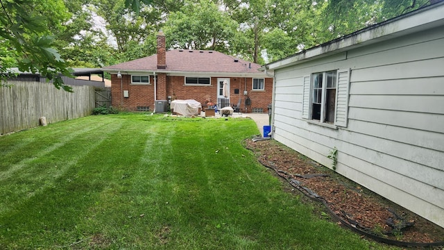 view of yard featuring a patio area and central AC