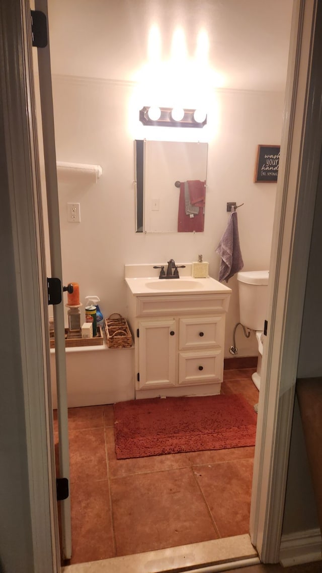 bathroom with tile patterned floors, vanity, and toilet