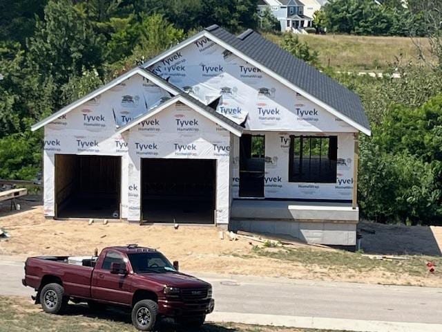 13828 S Azmiuth Dr, Traverse City, MI 49684 - property in mid-construction with an attached garage and driveway