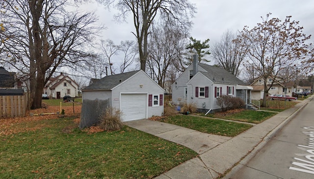 view of front of home with an outbuilding, a garage, and a front lawn