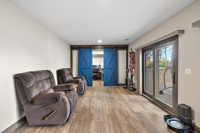 12120 Shaffer Rd, Davisburg, MI 48350 - living room with a barn door, light wood-style floors, baseboards, and recessed lighting
