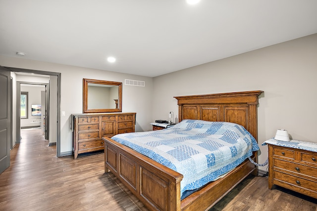 bedroom with dark hardwood / wood-style flooring