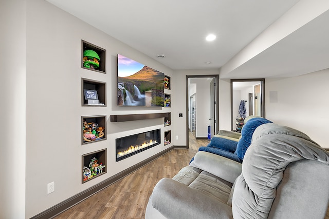 12120 Shaffer Rd, Davisburg, MI 48350 - sitting room featuring wood finished floors, a glass covered fireplace, baseboards, and recessed lighting