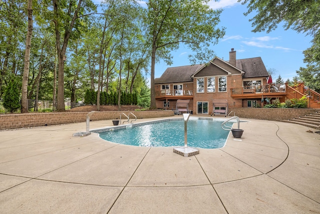 view of swimming pool with a patio area and a deck