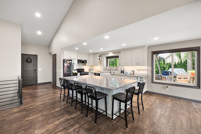 kitchen featuring white cabinetry, dark wood-type flooring, a center island, and stainless steel appliances